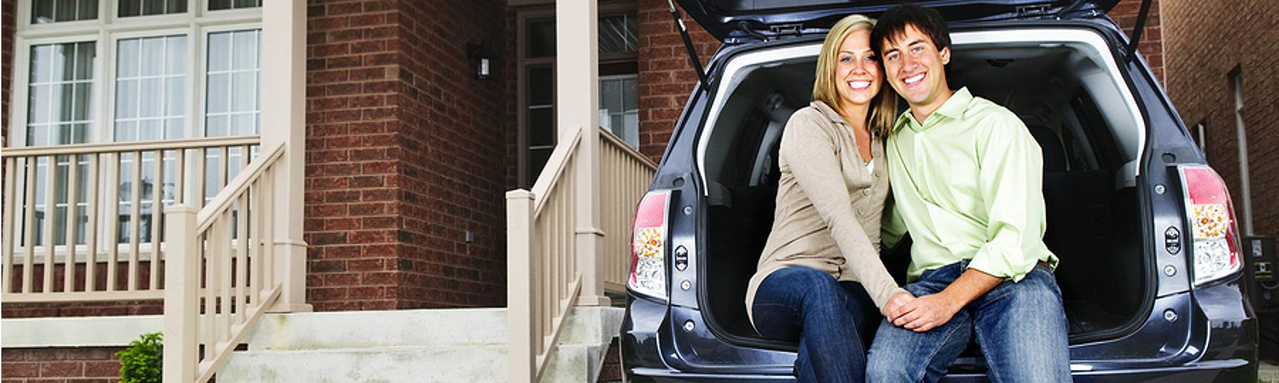 couple posing in back of an SUV